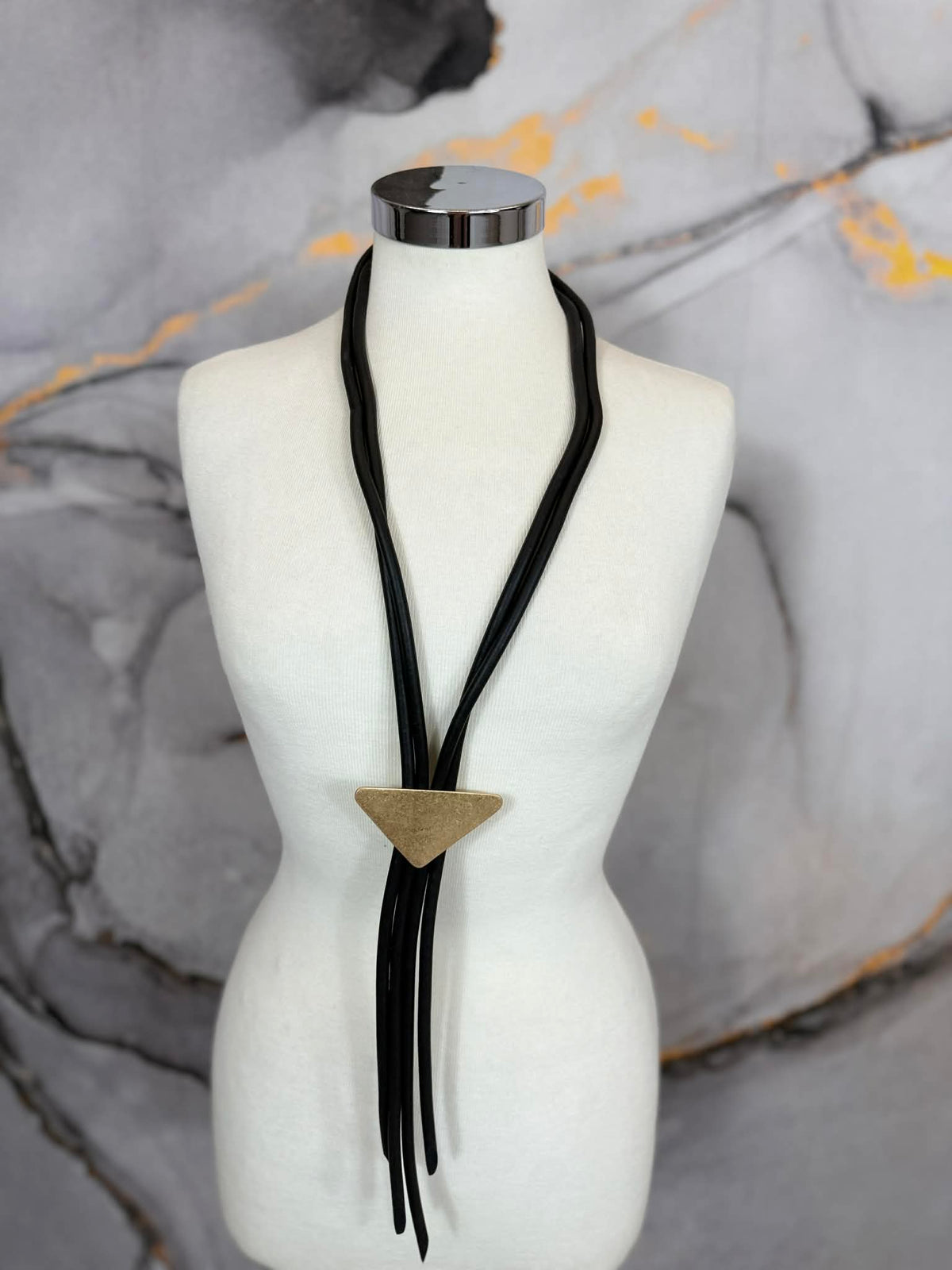 Rubber strand necklace with triangle