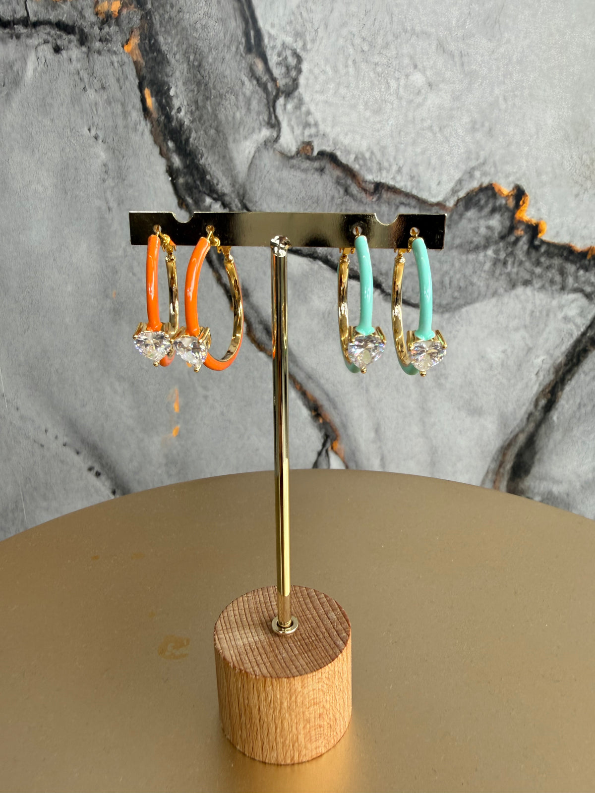 Colored hoop earring with a small heart