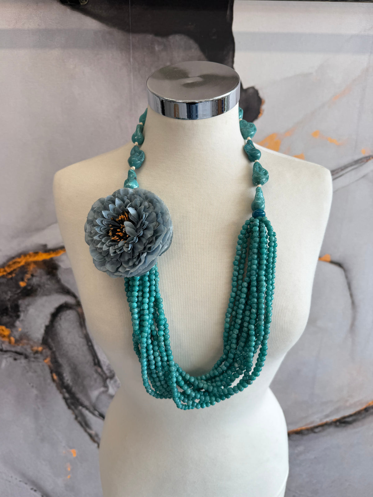 Beaded necklace with teal flower